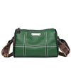 A dark green vintage genuine leather women's shoulder bag with white stitching and brown leather strap.
