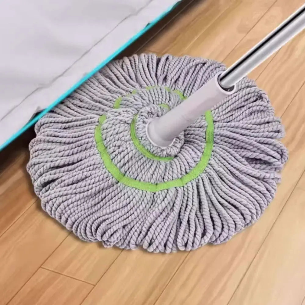 A gray, hand-free self-wringing spin mop with a rotating head is shown on a wooden floor.