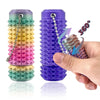 A hand holds a purple spiky fidget keychain, showing a 360-degree view of the textured product.