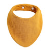 A mustard yellow organic cotton muslin baby bib with an absorbent band around the neck.