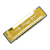 A gold-colored harmonica with a clear plastic body and a metal shell featuring a decorative script.