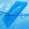 A bright blue honeycomb silicone seat cushion floating in clear water.