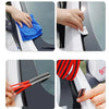 Hands cleaning a car window with a blue cloth and a rubber seal strip.