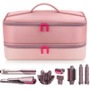 A pink double-layer travel storage bag containing a hair dryer and various accessories like a straightener and curling iron.
