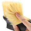 A hand holds a yellow car interior detailing brush set with soft bristles.