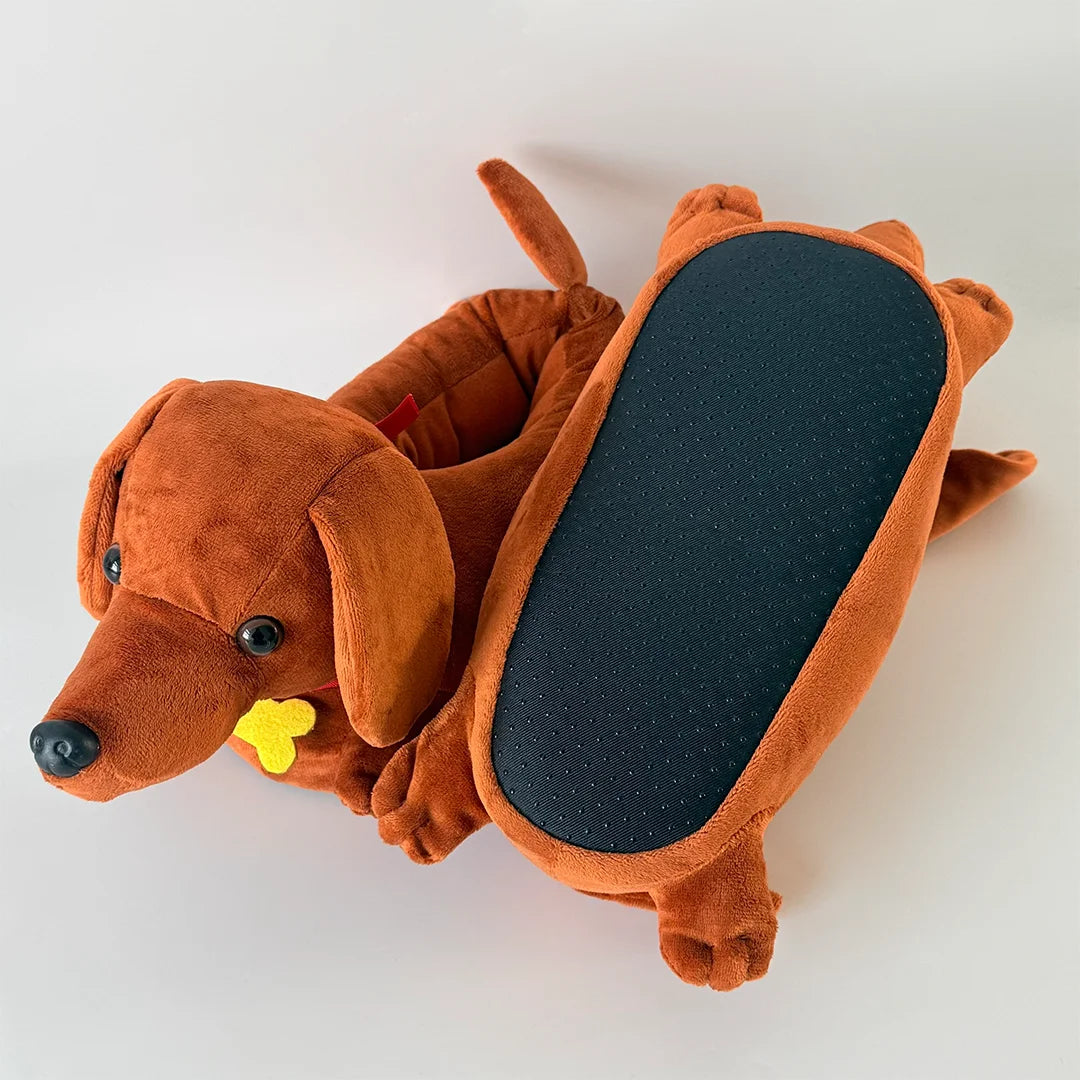 An orange plush dog house shaped like a dachshund is shown lying on a white surface.