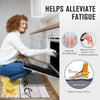 A person is using a non-slip mat in a kitchen setting to alleviate fatigue.