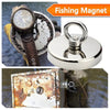 A fishing magnet is shown alongside a watch and a rusted metal box near water.