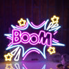 A neon sign spelling BOOM in bright pink and blue outlines, illuminated against a dark background.