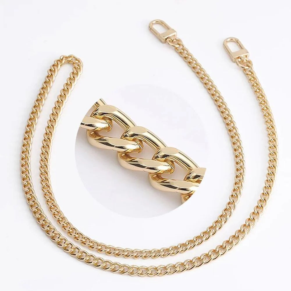 Gold metal purse chain with buckles shown against a white background.