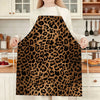 A person wearing a brown and black leopard print kitchen apron standing in a kitchen setting.