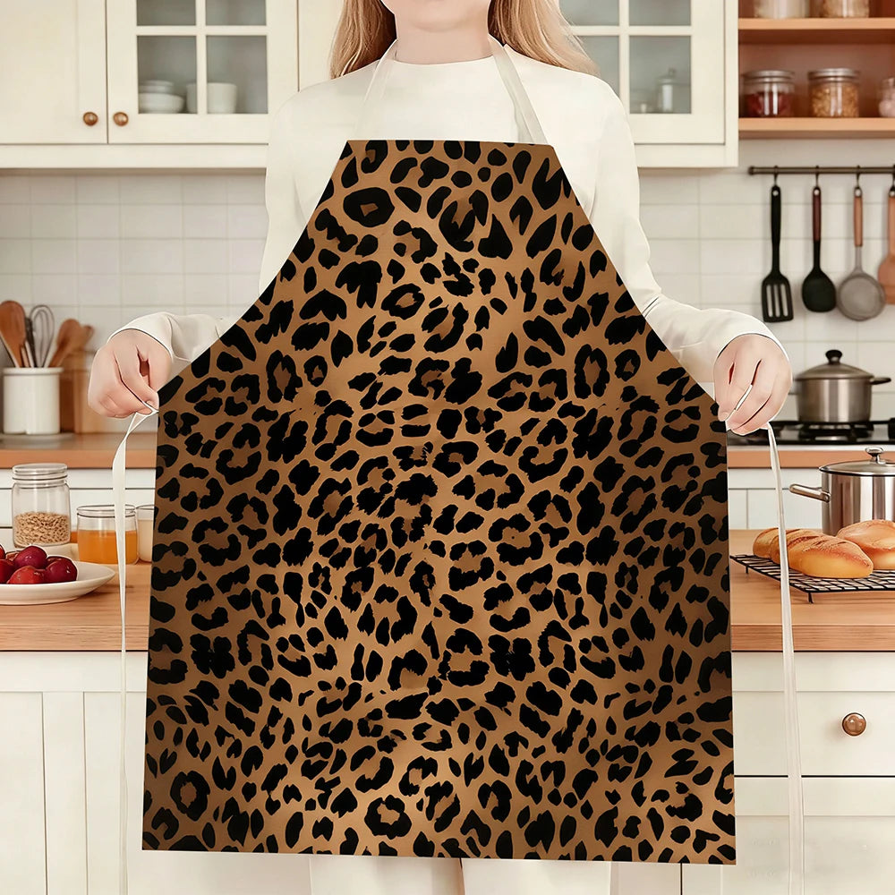 A person wearing a brown and black leopard print kitchen apron standing in a kitchen setting.