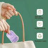 A hand is placing a lavender scented paper soap into a canvas tote bag, with icons indicating it is suitable for a suitcase, 
