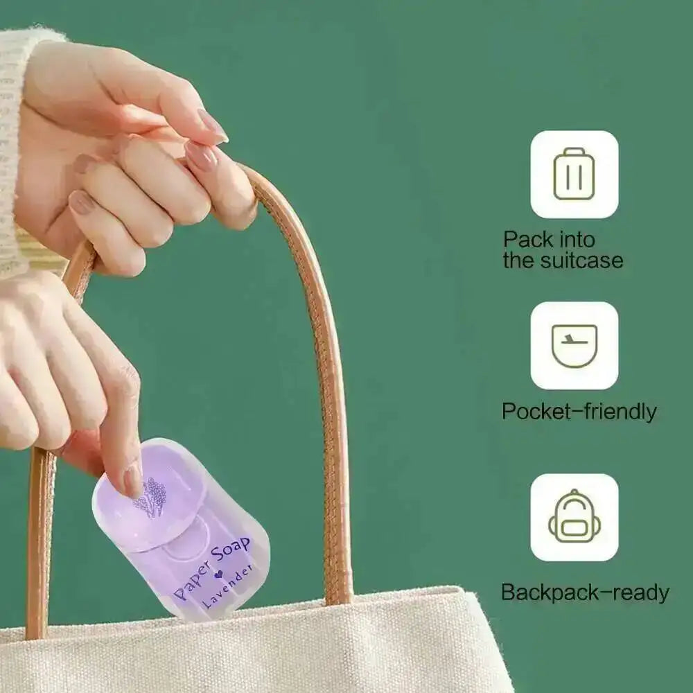 A hand is placing a lavender scented paper soap into a canvas tote bag, with icons indicating it is suitable for a suitcase, 