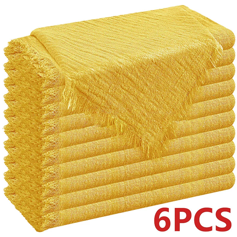 A stack of six golden yellow raw-edge polyester cloth napkins.
