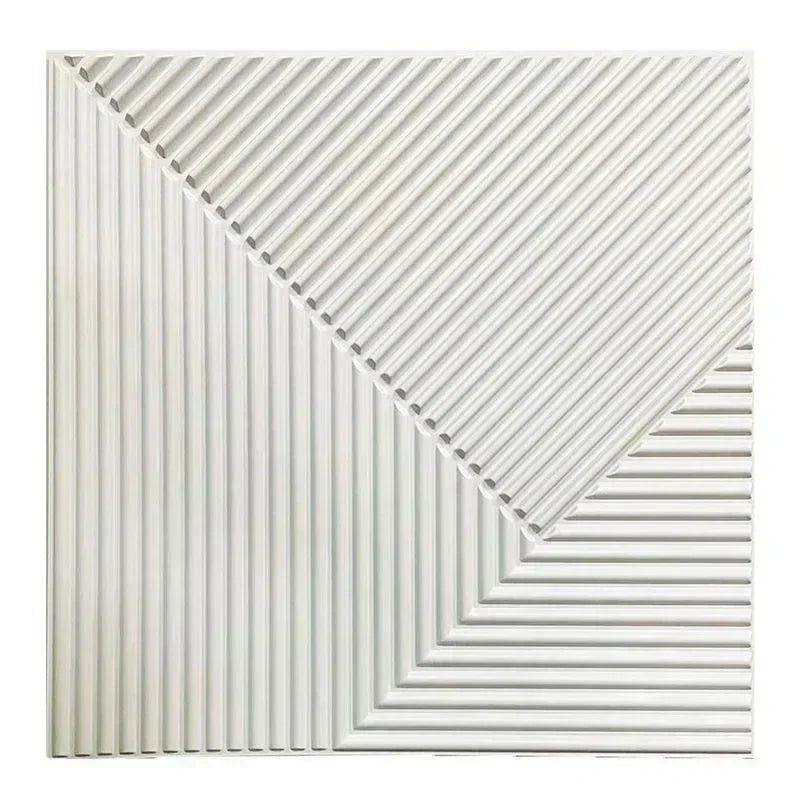 A close-up view of white, ribbed 3D diamond wall panels arranged in a geometric pattern.