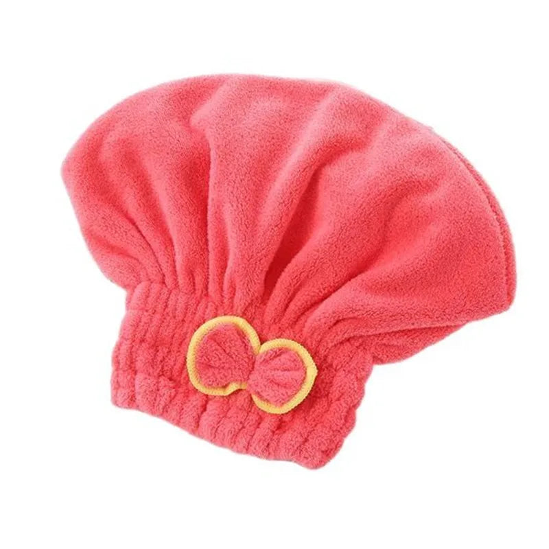 A bright coral pink microfibre quick-dry hair towel wrap with a decorative bowknot.