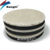Stack of black and white car polishing wool pads with foam backing for scratch removal