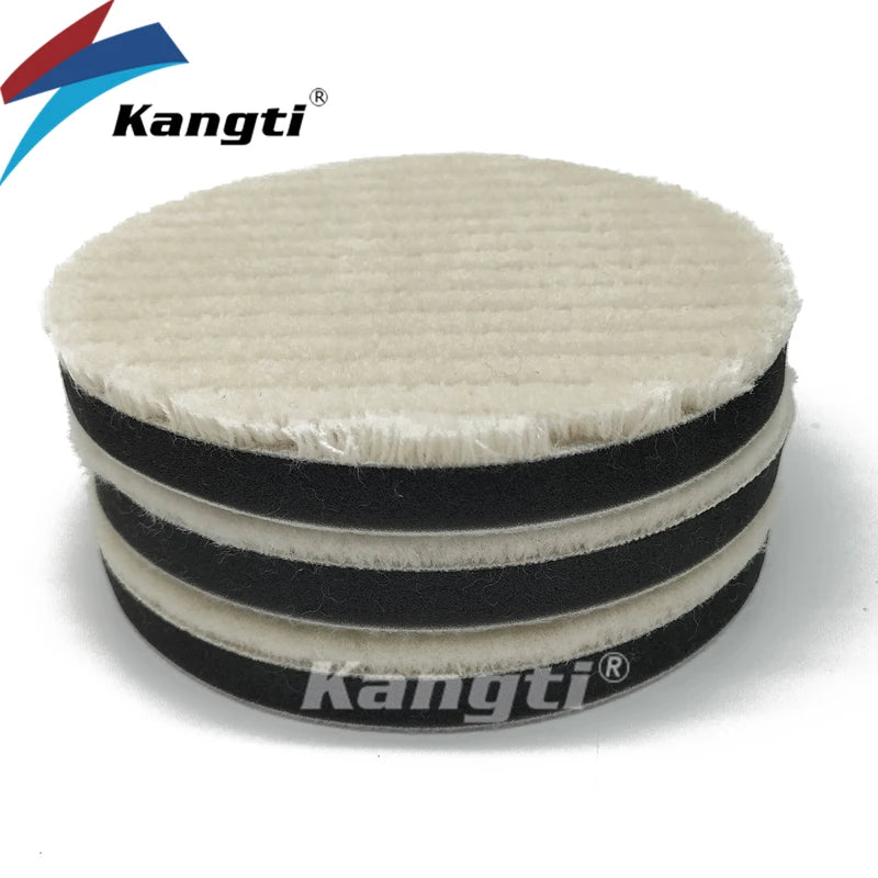 Stack of black and white car polishing wool pads with foam backing for scratch removal