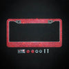 A red crystal rhinestone license plate frame with screw caps and mounting hardware.