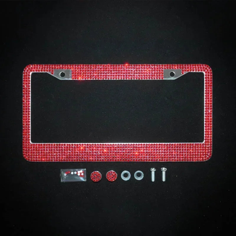 A red crystal rhinestone license plate frame with screw caps and mounting hardware.