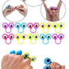 A set of colorful eye finger puppet rings for kids, shown on a hand and in various angles.