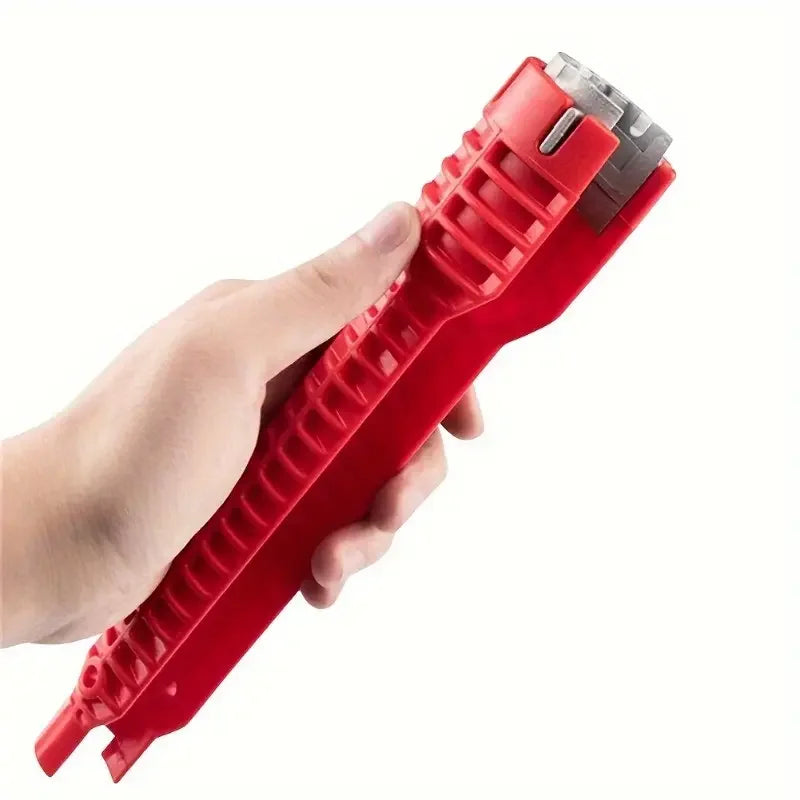 A hand is holding a red multifunctional faucet and sink wrench set.