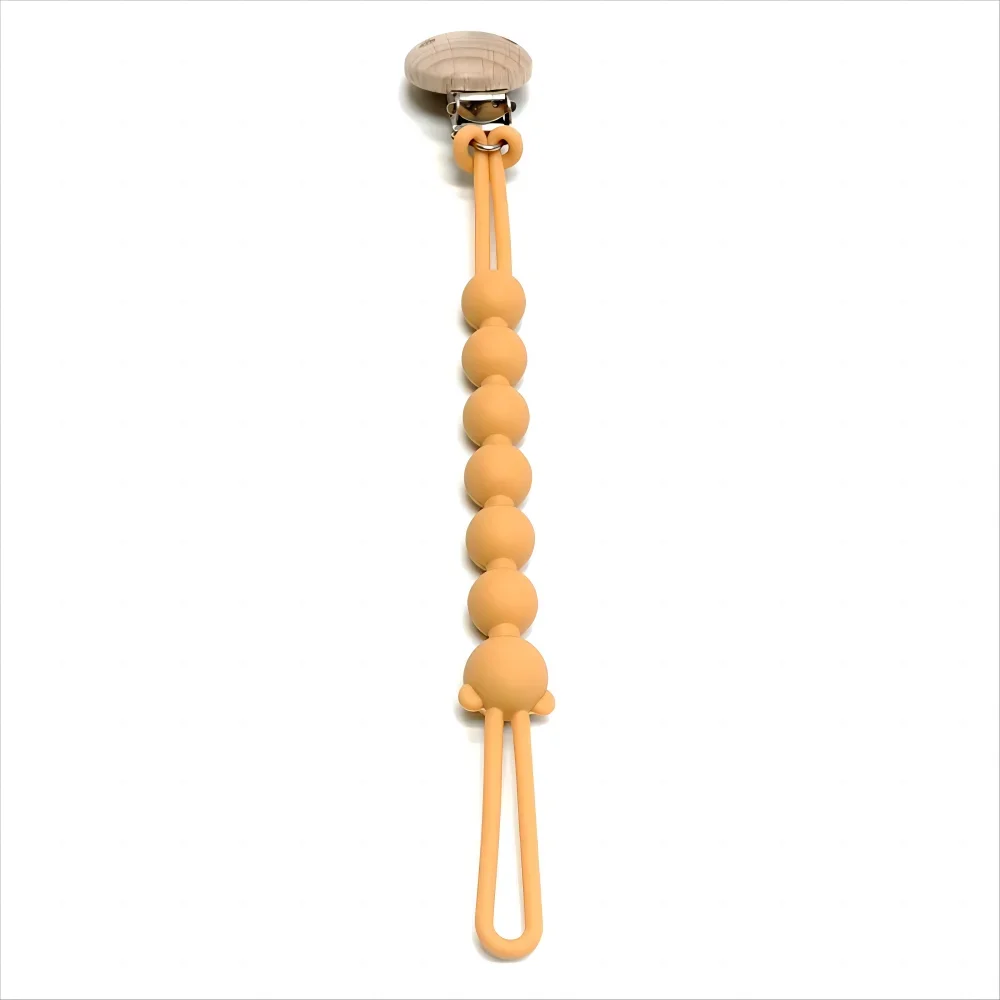 A food-grade silicone pacifier clip with an anti-lost chain, featuring a light orange color.
