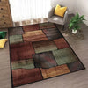 Abstract geometric area rug featuring earthy tones of brown, olive green, and charcoal on a gray floor.