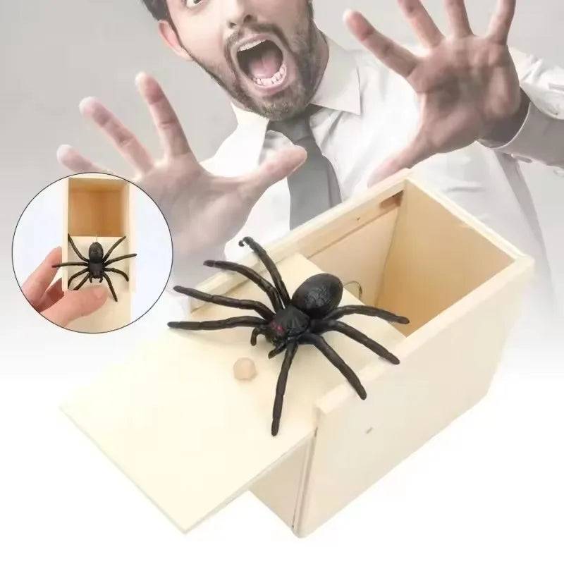 A wooden box with a pop-out mechanism is shown next to a hand displaying a spider.