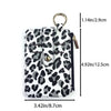 Leopard print PU leather card holder with a coin pocket and keychain, shown in a vertical orientation.