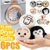 A set of six natural wool dryer balls shaped like animals, including a panda, pig, and others, displayed next to a washing ma
