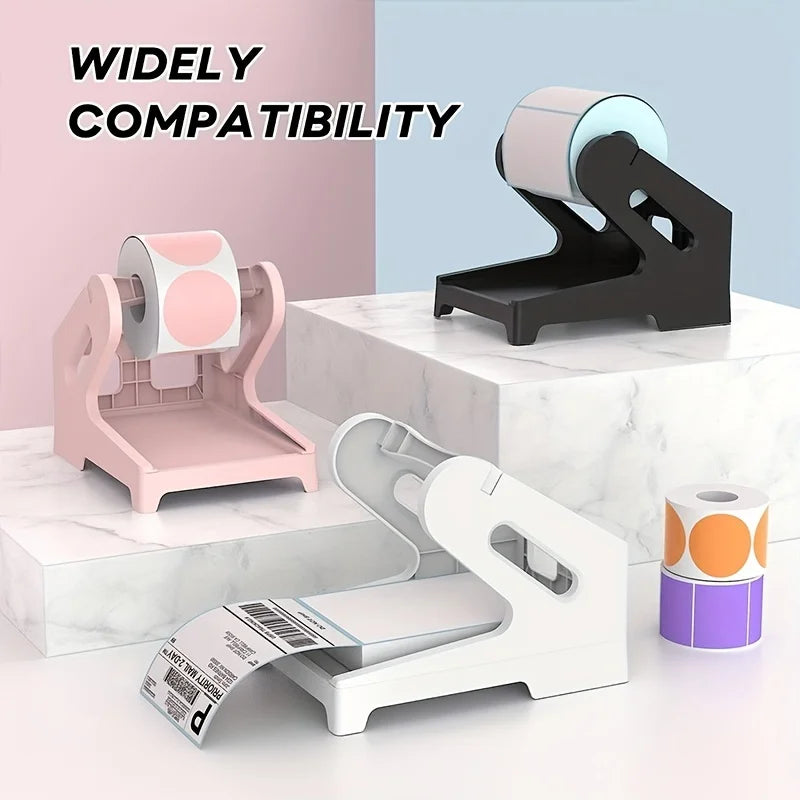 A set of pink and white thermal label holders for rolls and fan-folded labels displayed on a white marble surface.