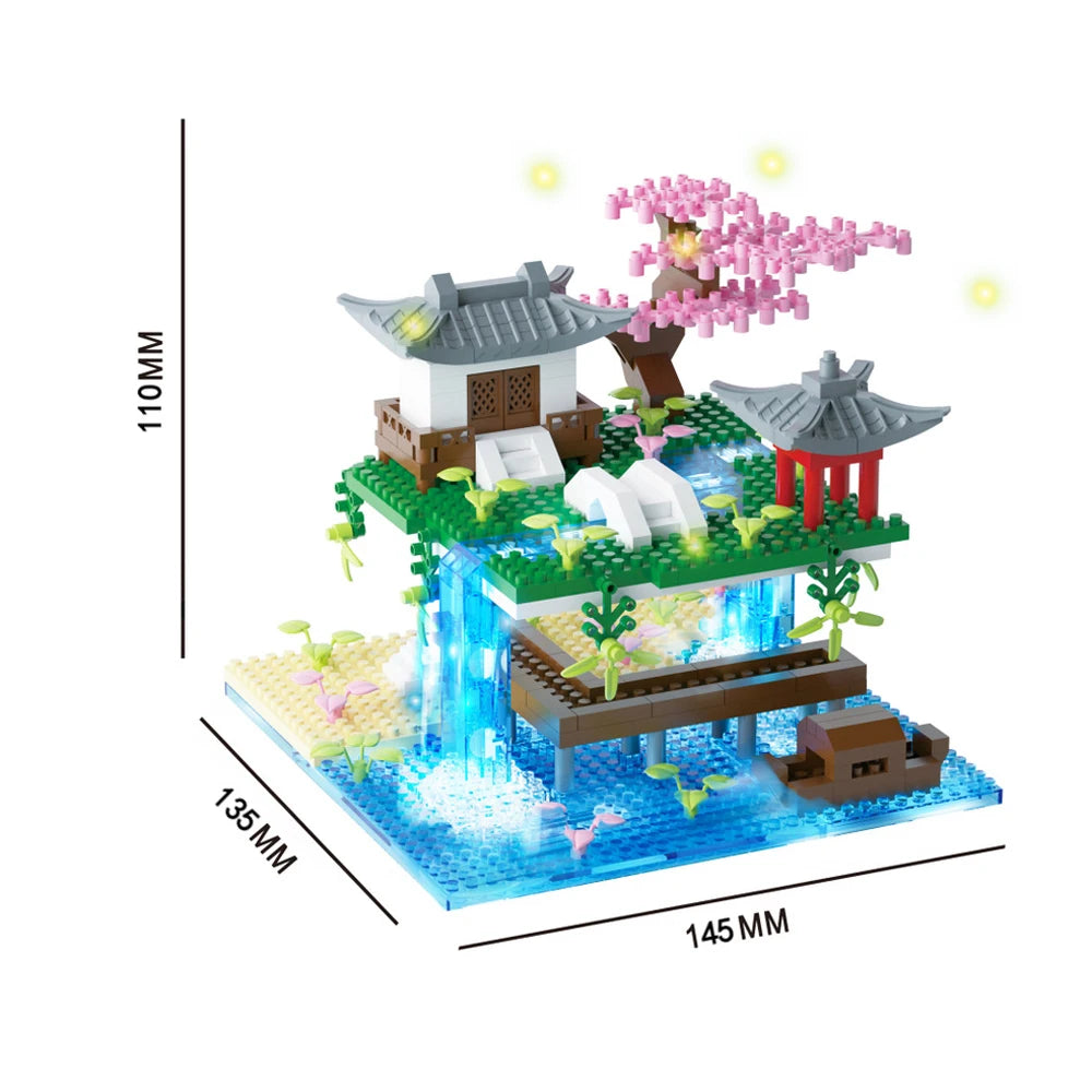 A micro building block set depicting a pink sakura treehouse with a traditional Japanese-style roof and water features.