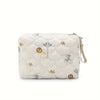 A cream-colored quilted baby diaper caddy organizer with a rainbow print design and attached straps.