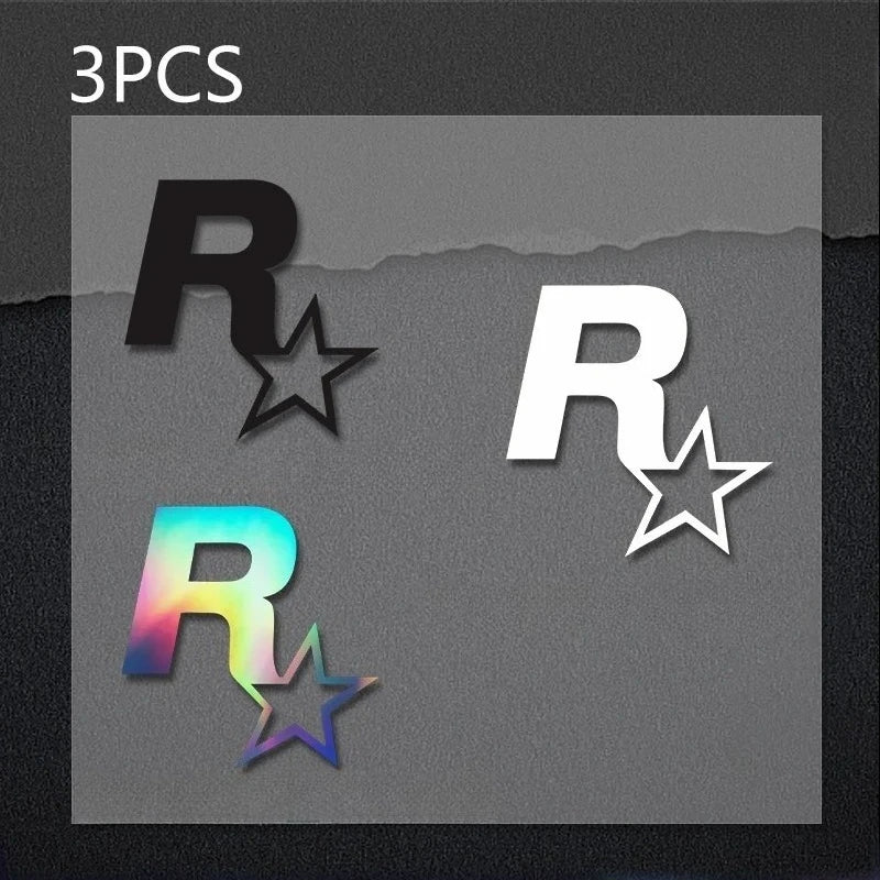 Three reflective R-star vinyl stickers, one black, one white, and one iridescent color, displayed on a dark background.