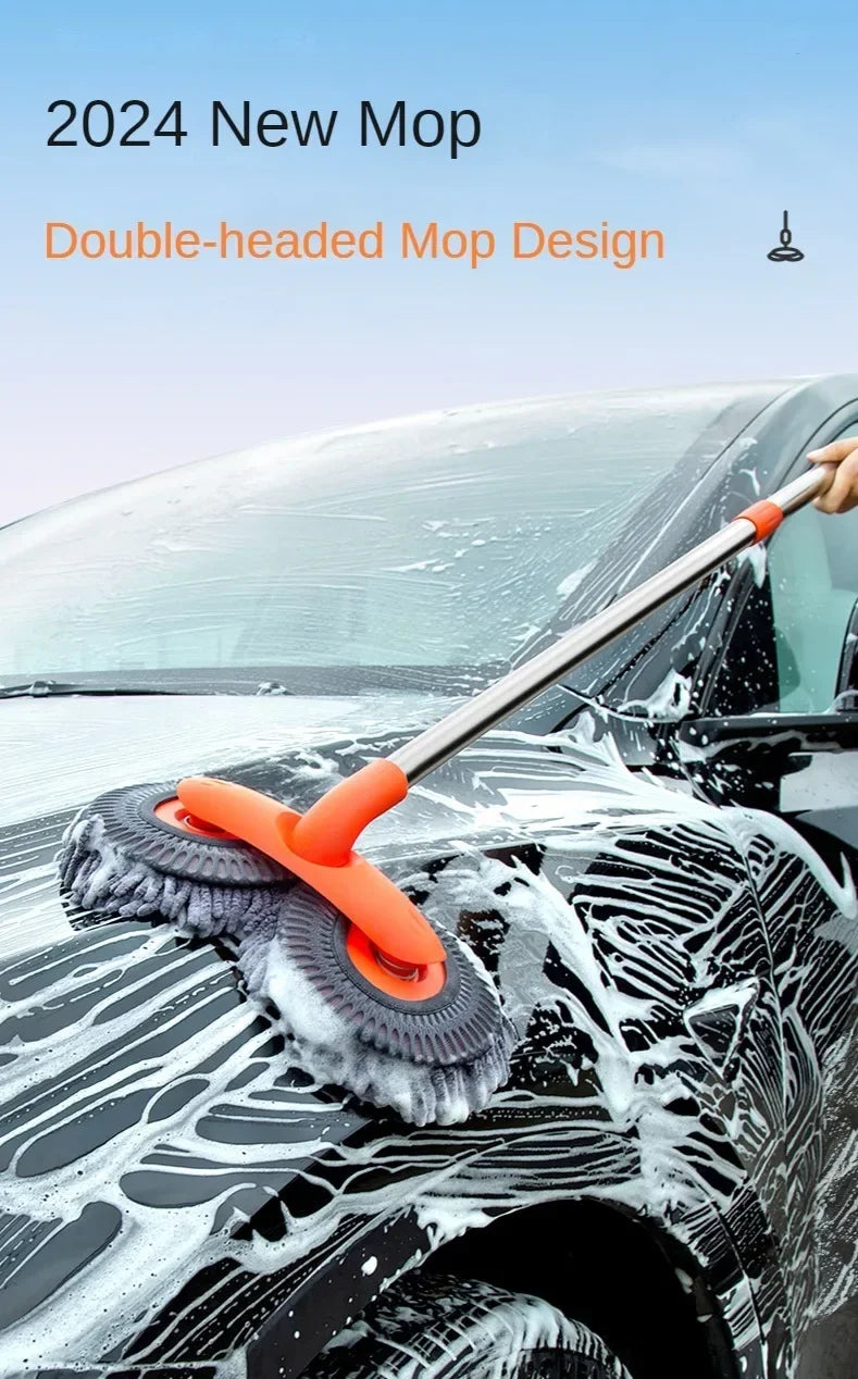 An orange double-headed extendable mop is shown washing water off a black car's windshield.