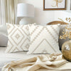 A decorative pillowcase with a geometric diamond pattern in beige and white on a light background.