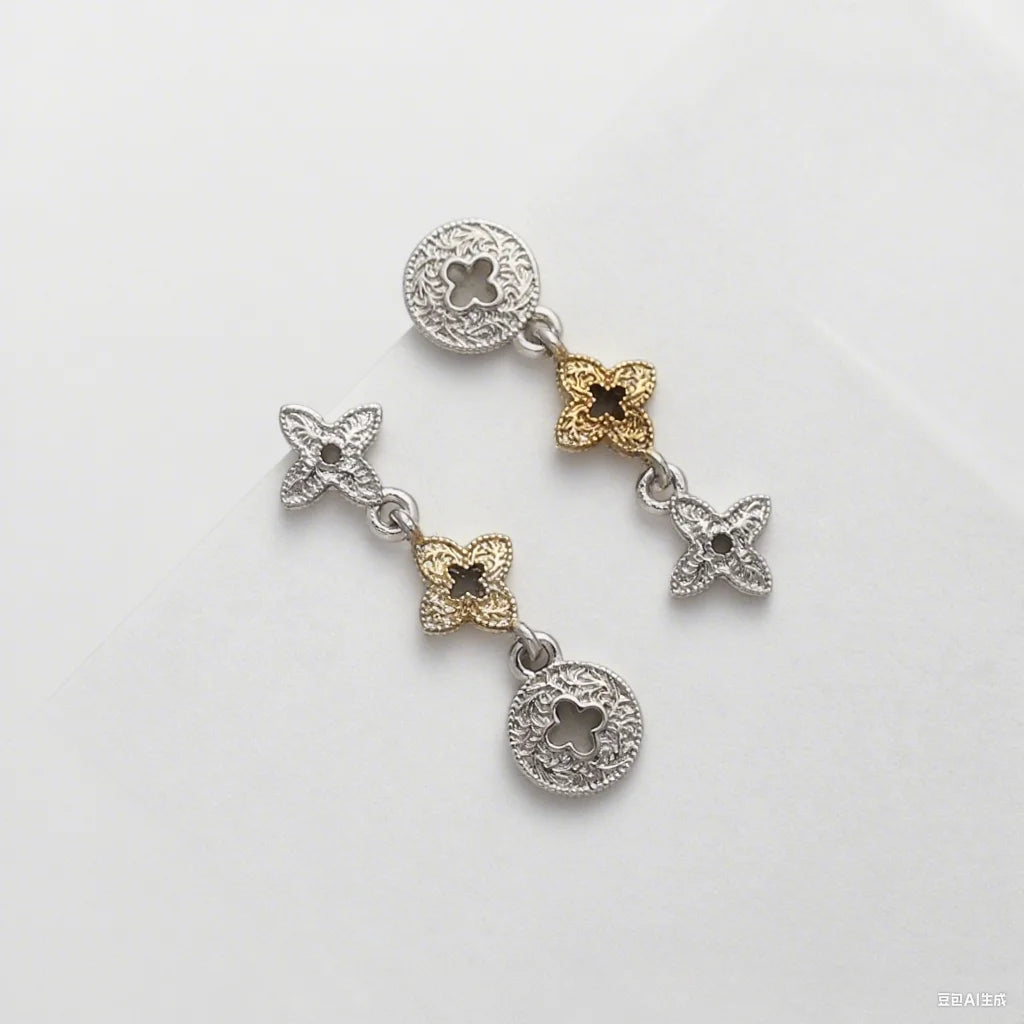 A pair of two-tone clover stud earrings featuring silver and gold accents.