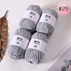 A stack of gray Milk Cotton yarn skeins for knitting and crochet projects.