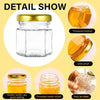 Detail show of a clear glass honey jar with a gold lid, showing its thickened bottom, leak proof seal, threaded mouth, and ea