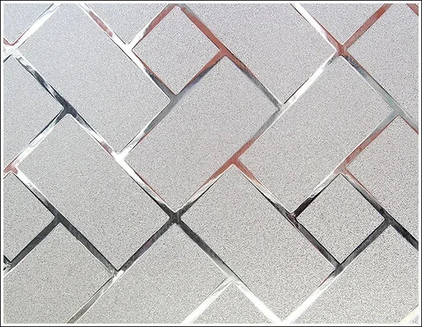 Decorative frosted window privacy film featuring a diamond-patterned design with a silver and rose gold tint.