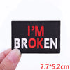 Black embroidered iron-on letter patch with red text that reads I'M BROKEN