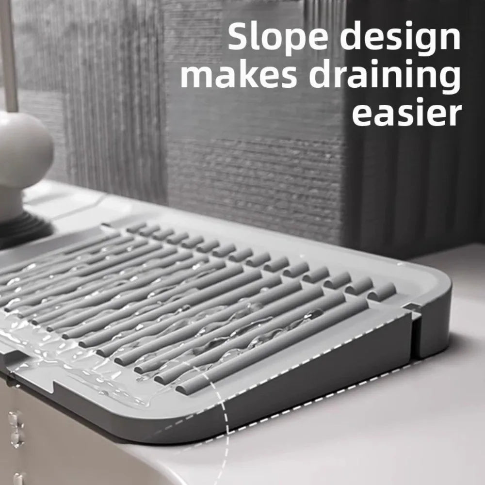 A silicone faucet draining mat with a slope design is shown on a white surface.
