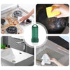 A reusable green limescale and stain eraser tool is shown being used on a faucet, sink, and tile.