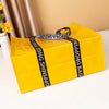 A bright yellow waterproof tote bag with black straps is shown on a white surface.