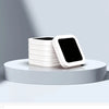 A stack of white replacement refill rings for a smart kitchen trash can displayed on a light gray surface.