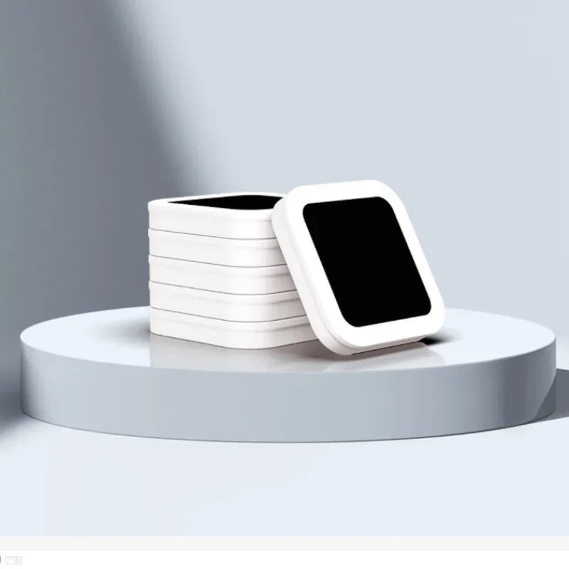 A stack of white replacement refill rings for a smart kitchen trash can displayed on a light gray surface.