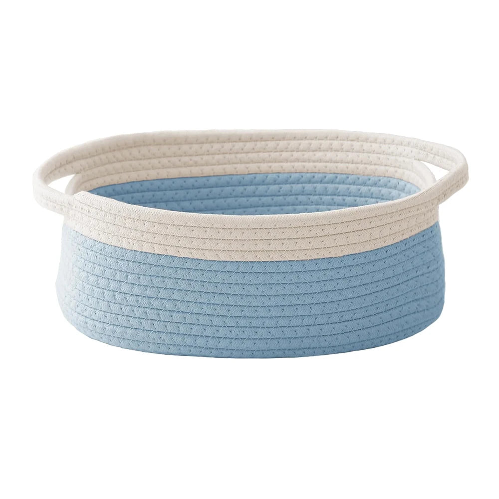 Handwoven rope storage basket in light blue and cream colors with handles