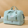 A light mint green nylon travel duffle bag with light gray straps and silver hardware.